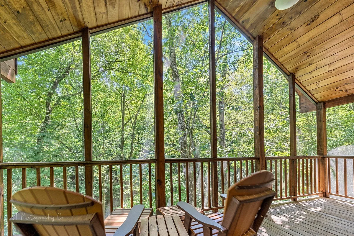 A serene sitting area with large windows, wooden beams, and adirondack chairs, offering views of the surrounding nature. The space feels peaceful yet social, perfect for relaxing together while soaking in the scenery or planning the next outing.